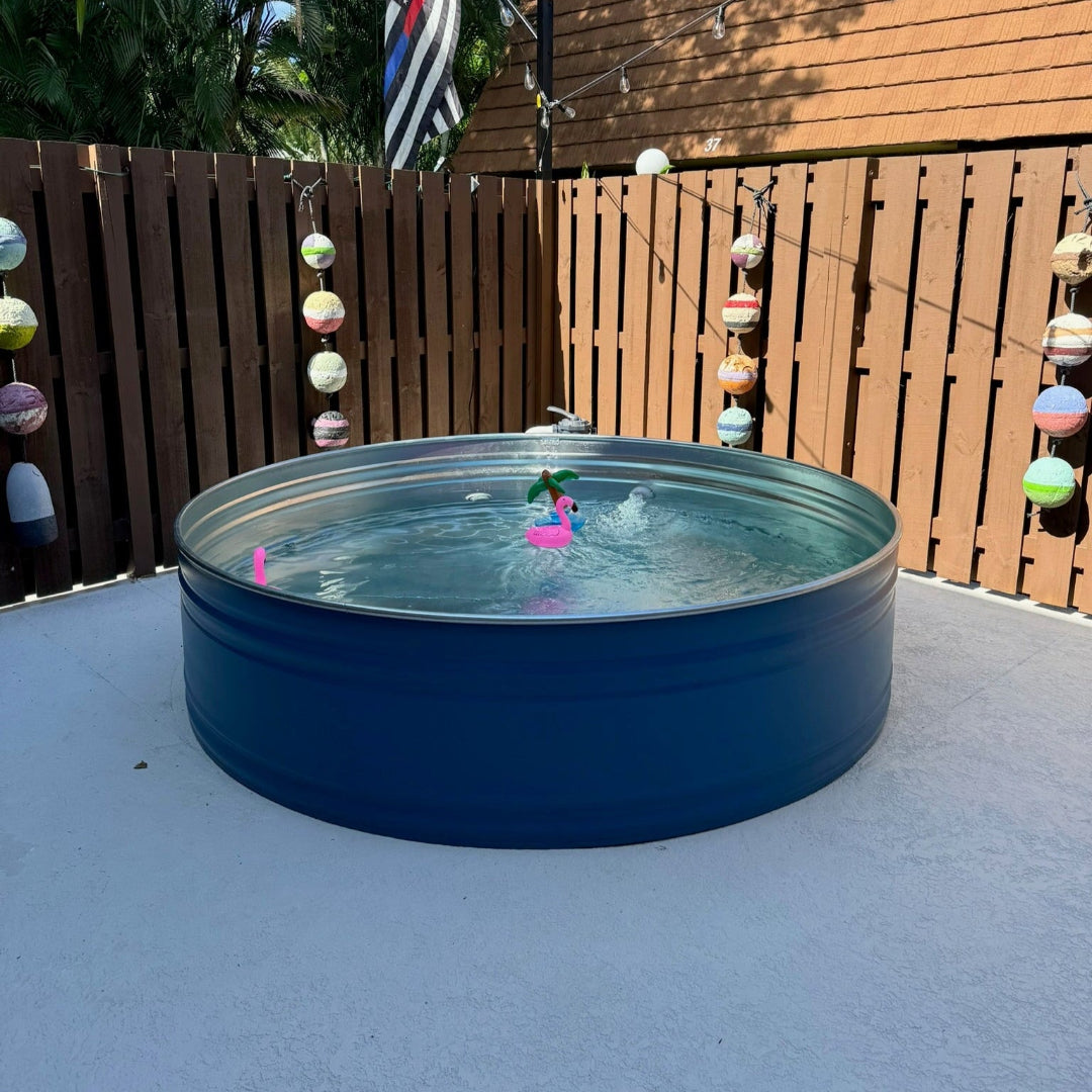 Blue above-ground pool with pink flamingo float on a patio