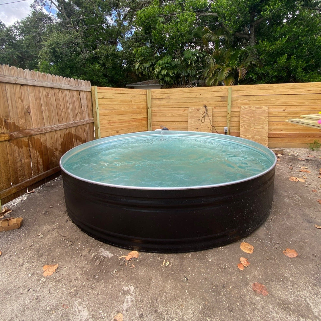 Circular above-ground pool in a backyard with trees and a wooden fence in the background.