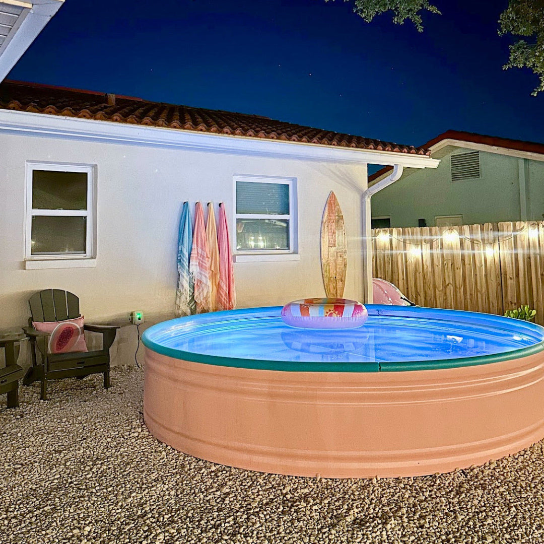 Portable inflatable pool in a backyard at night with lights on