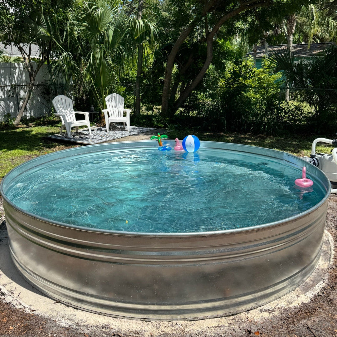 Metallic stock tank pool with children's toys in a backyard setting