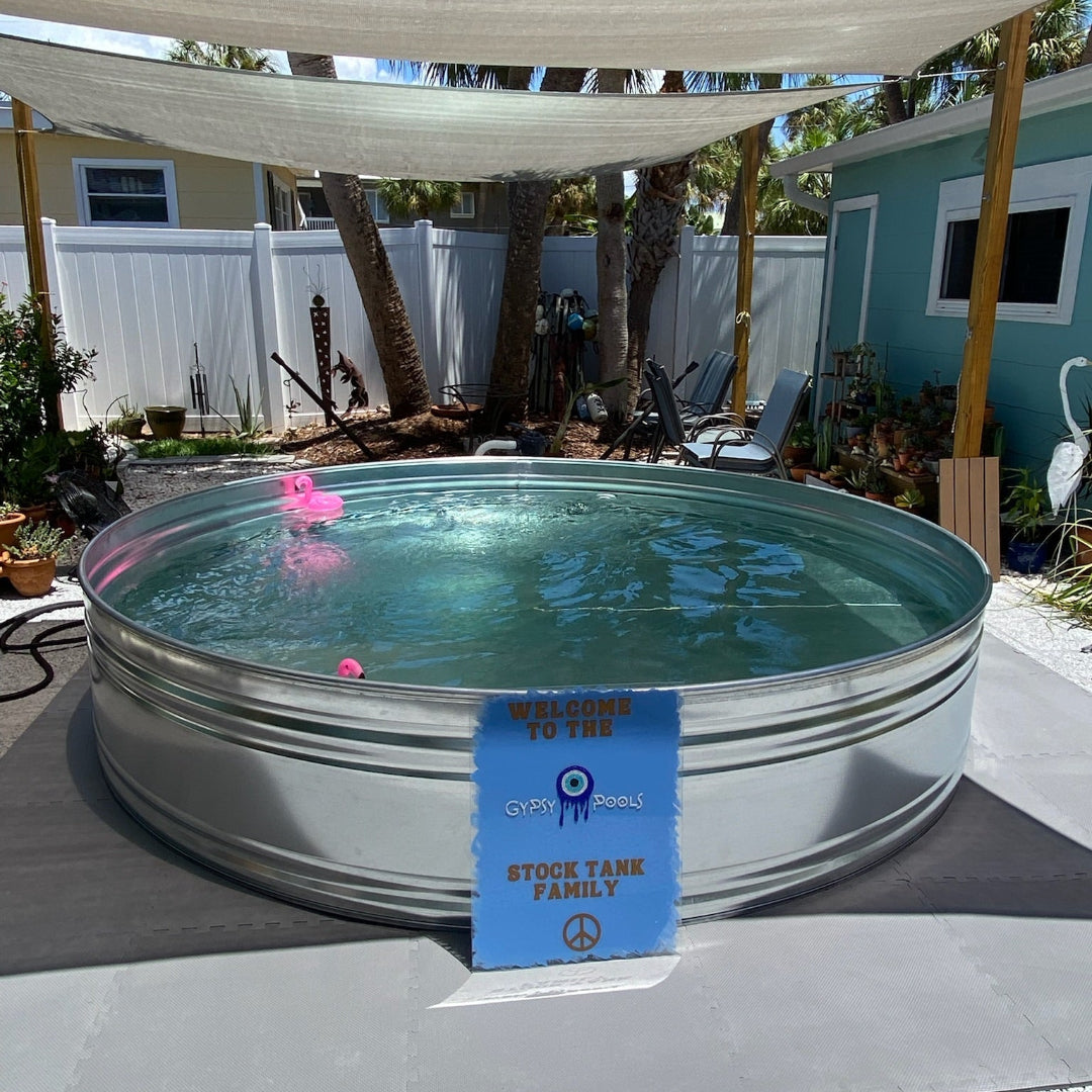 Metal stock tank pool with a blue tag on a patio