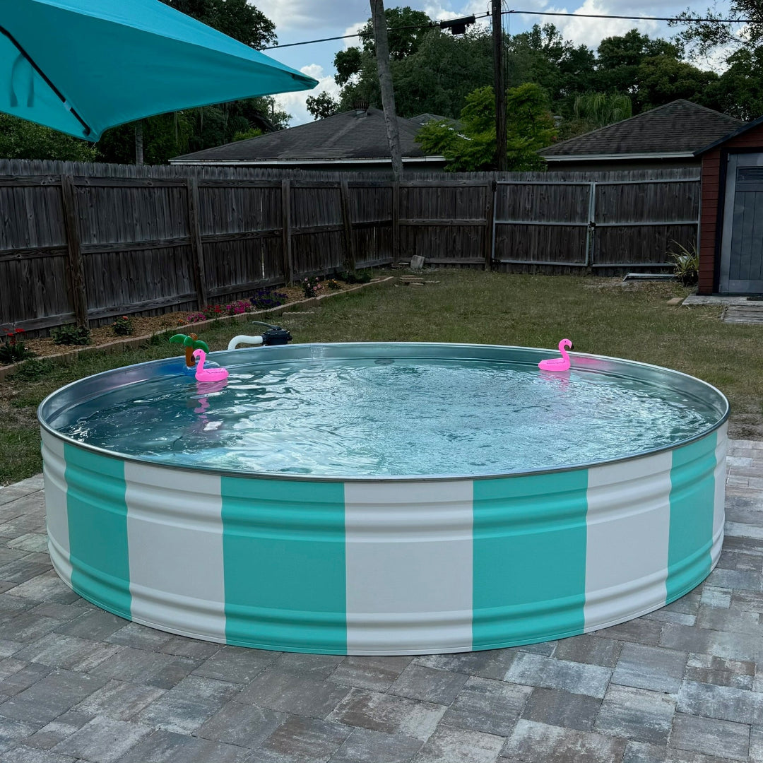 Round above-ground pool with teal and white striped sides in a backyard setting.