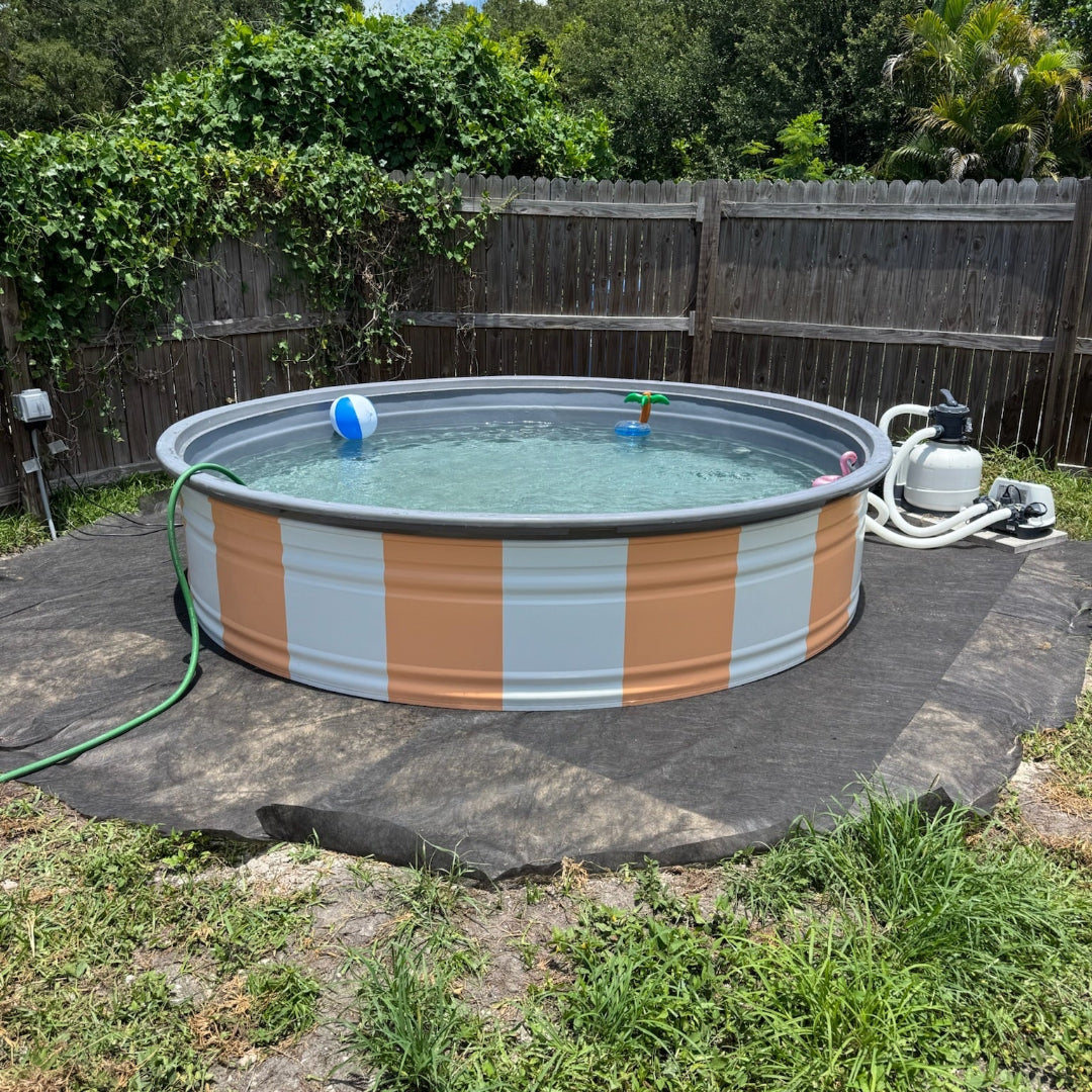 Round above-ground pool with striped design in a backyard setting