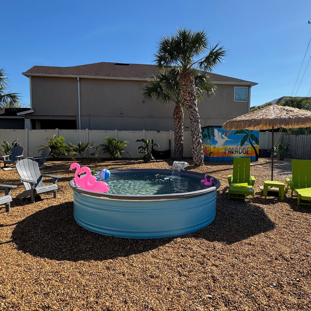 Portable pool with inflatable flamingo and lounge chairs in a backyard setting.