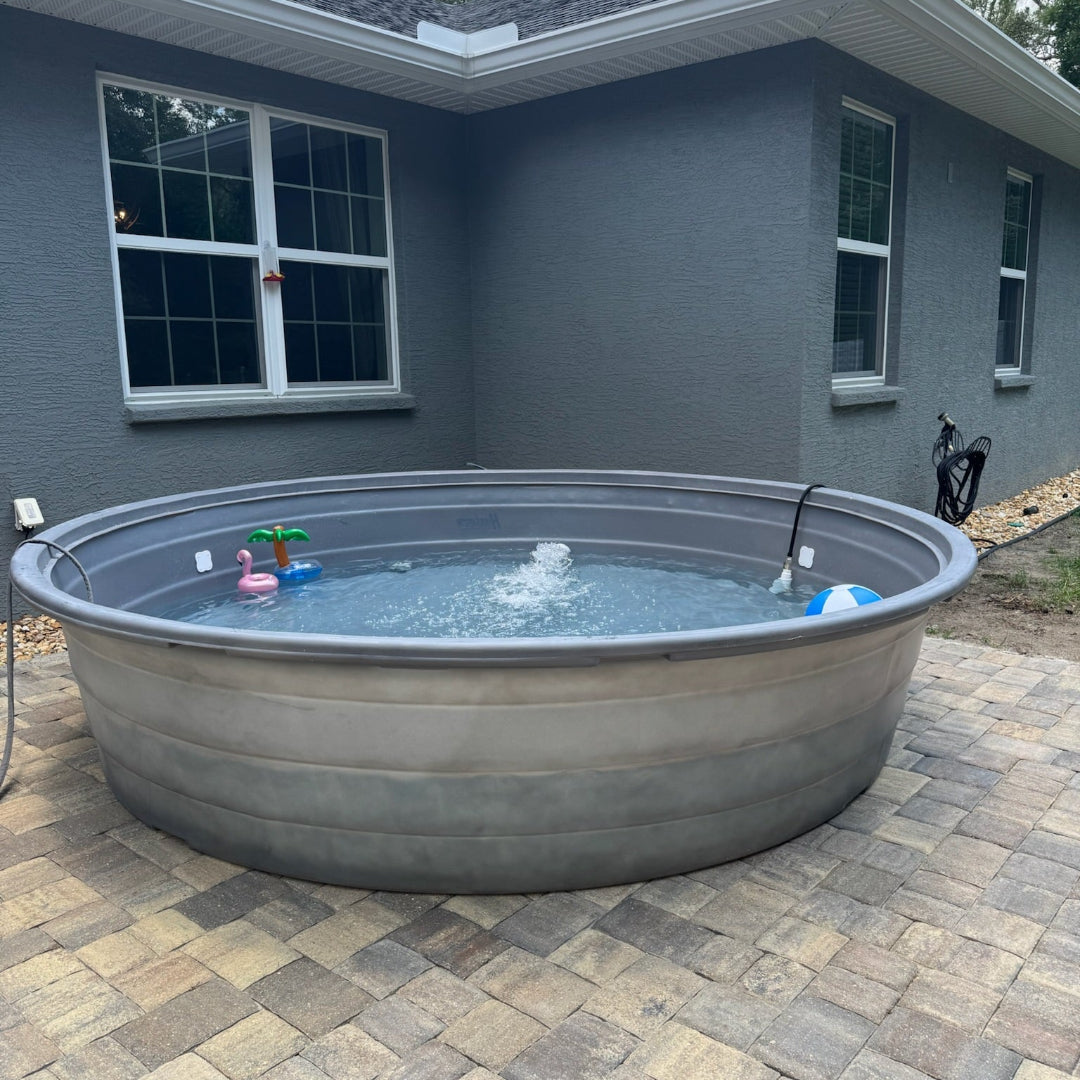 Round above-ground pool on a patio in front of a house