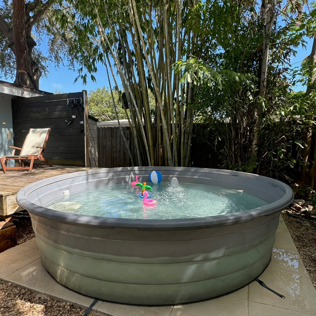 Inflatable hot tub in a backyard with trees and a deck in the background