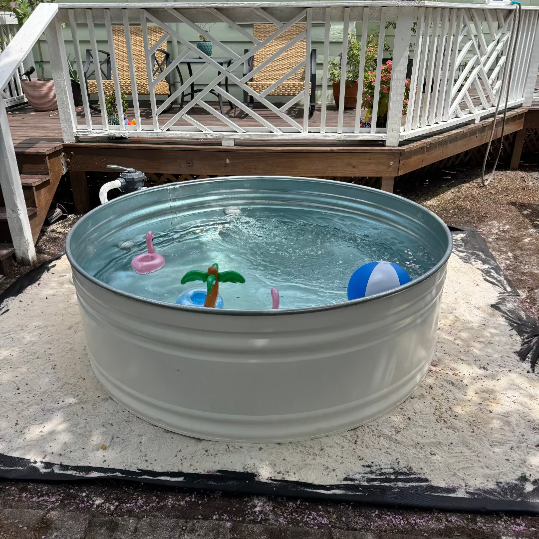 Metal water trough with toys on a patio