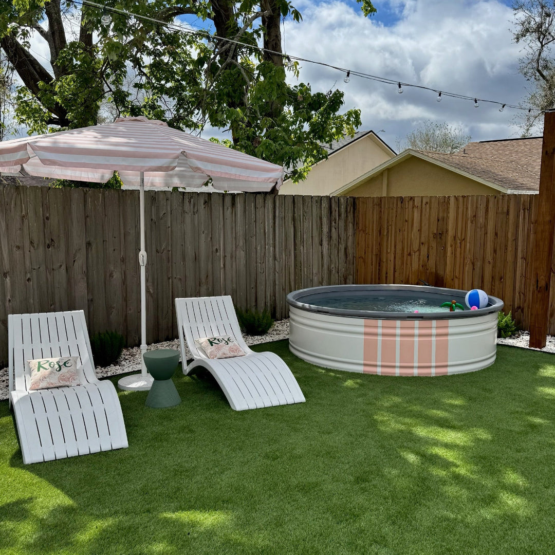 Backyard with lounge chairs, umbrella, and above-ground pool.