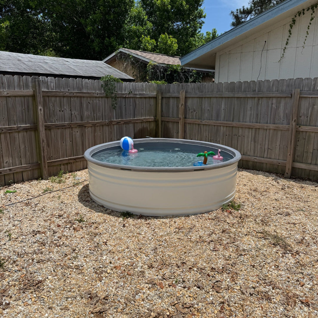 Small above-ground pool in a backyard with trees and a fence in the background.
