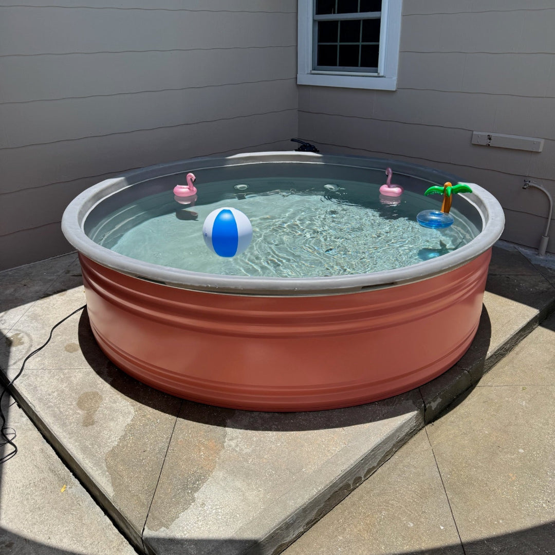 Stock Tank Hybrid pool with toys on a patio