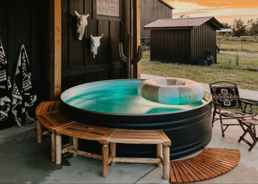 Outdoor hot tub with wooden benches and a scenic background