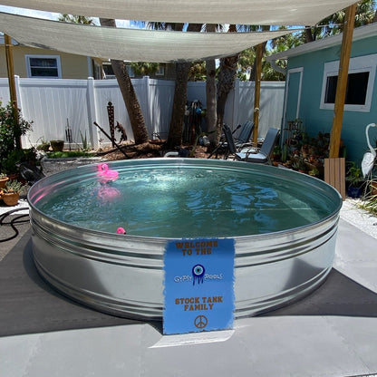 Metal stock tank pool with a blue tag on a patio