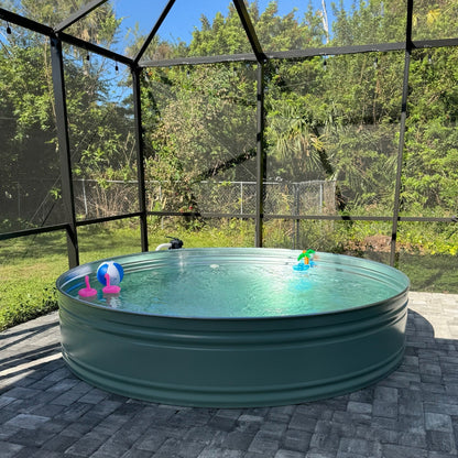 Green above-ground pool with children's toys in a backyard setting