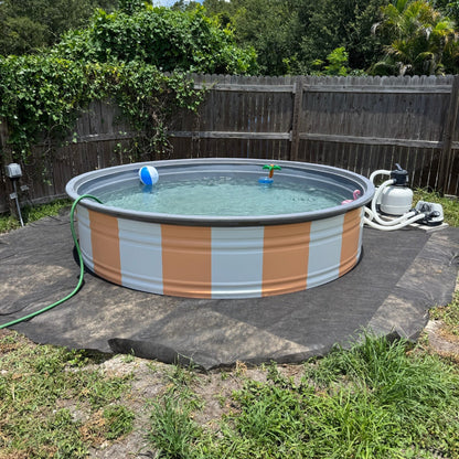 Round above-ground pool with striped design in a backyard setting