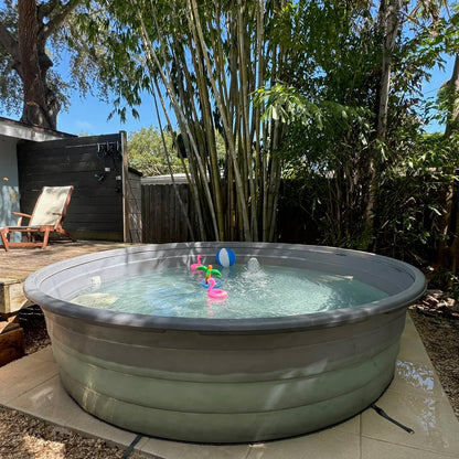 Inflatable hot tub in a backyard with trees and a deck in the background